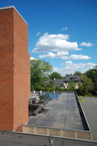 Looking down from a higher roof to a lower roof, towards the front of the hospital.